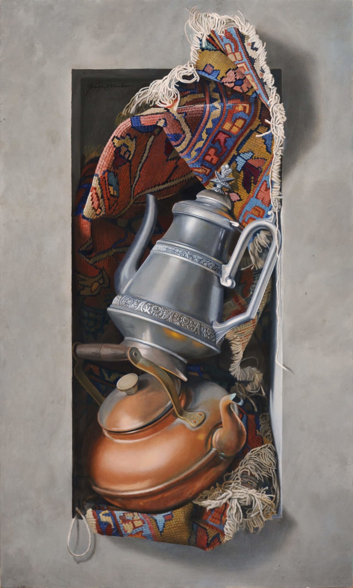 Still life arrangement of two old tea kettles and a piece of an old oriental rug. This objects are protruding out of a gray stone rectangular niche.